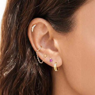 Model wearing Florentine hoop earrings in yellow gold with diamond accents.